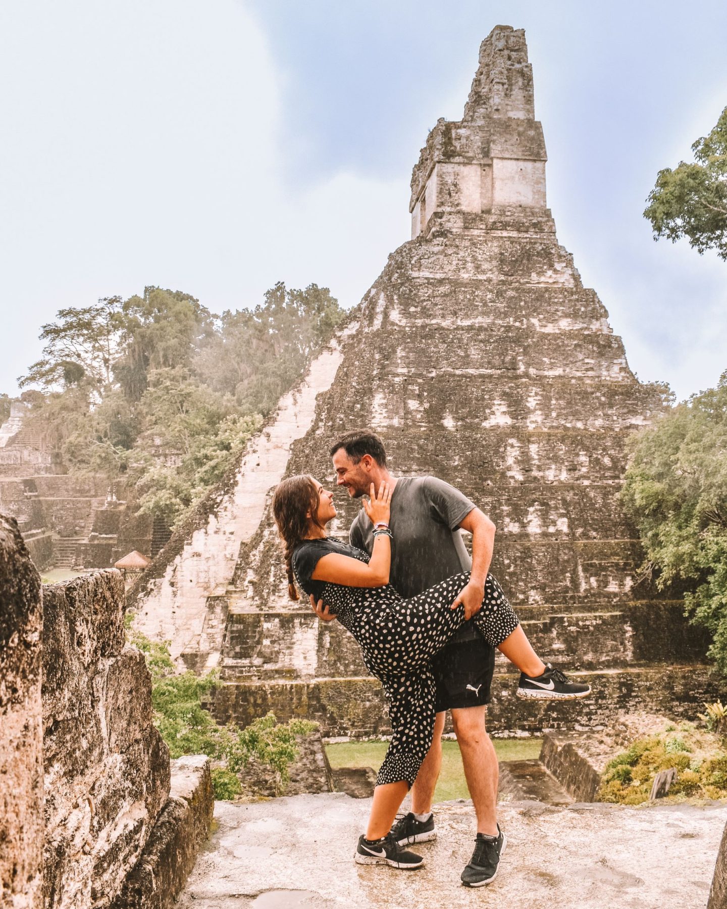 Visit Tikal Guatemala - travel couple in the rain