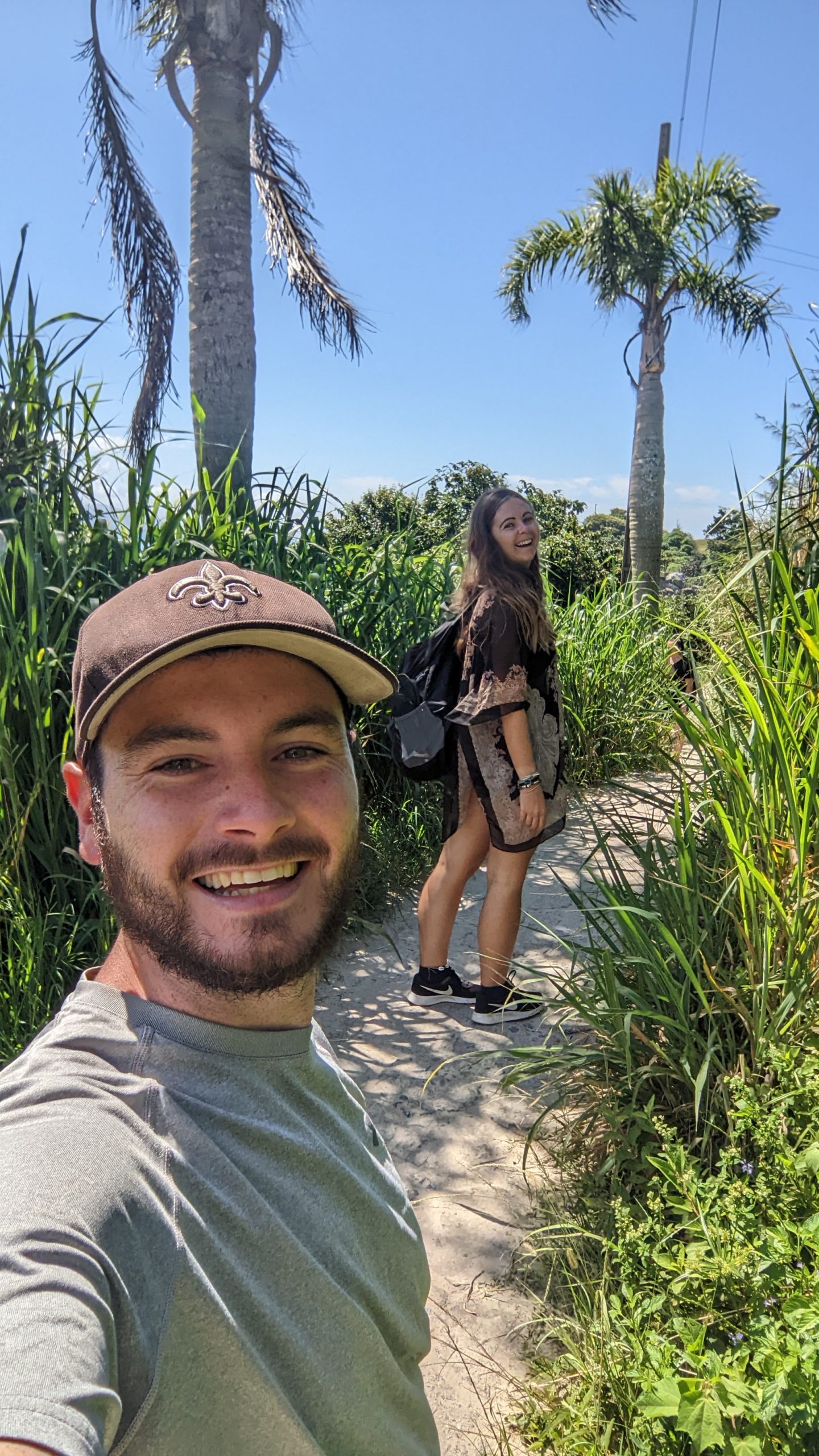 A happy travelling couple hiking to Lagoinha do Leste