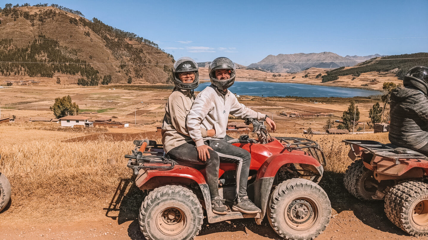 Quad Bike tour near Cusco, Peru on a day trip from Maras salt mines. Couple sit on a quad bike.
