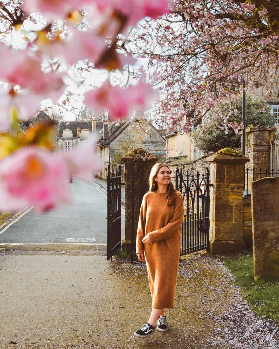 Reanna standing in the Cotswolds framed by cherry blossom