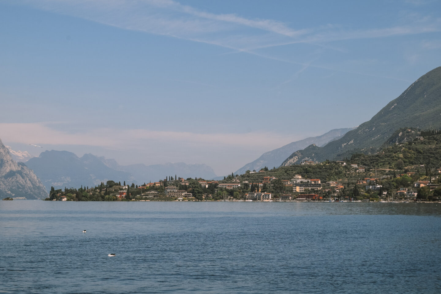 The view over Lake Garda with towns and the mountains in the distance