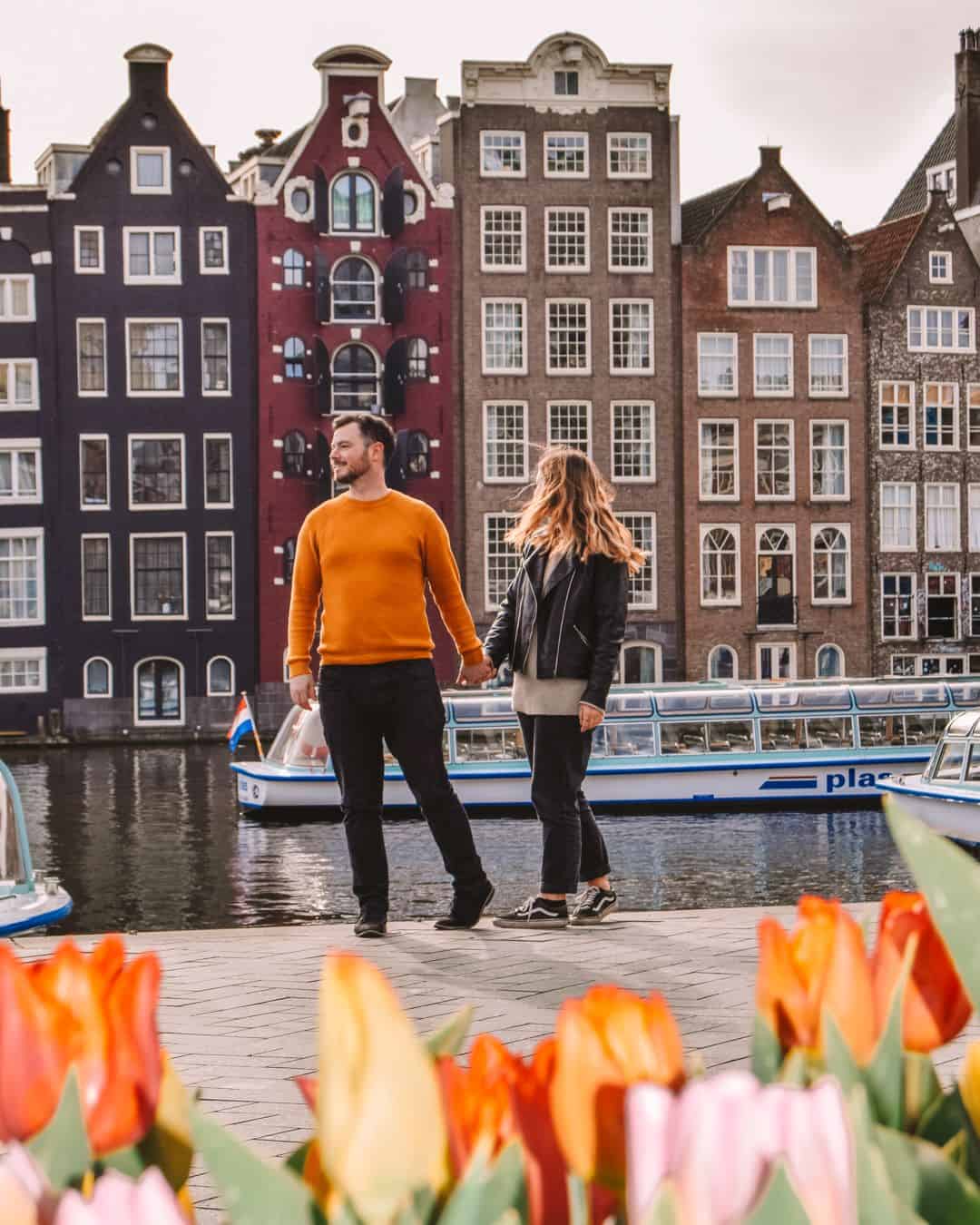 Chris and Reanna standing Infront of Amsterdam canal with flowers framing the bottom