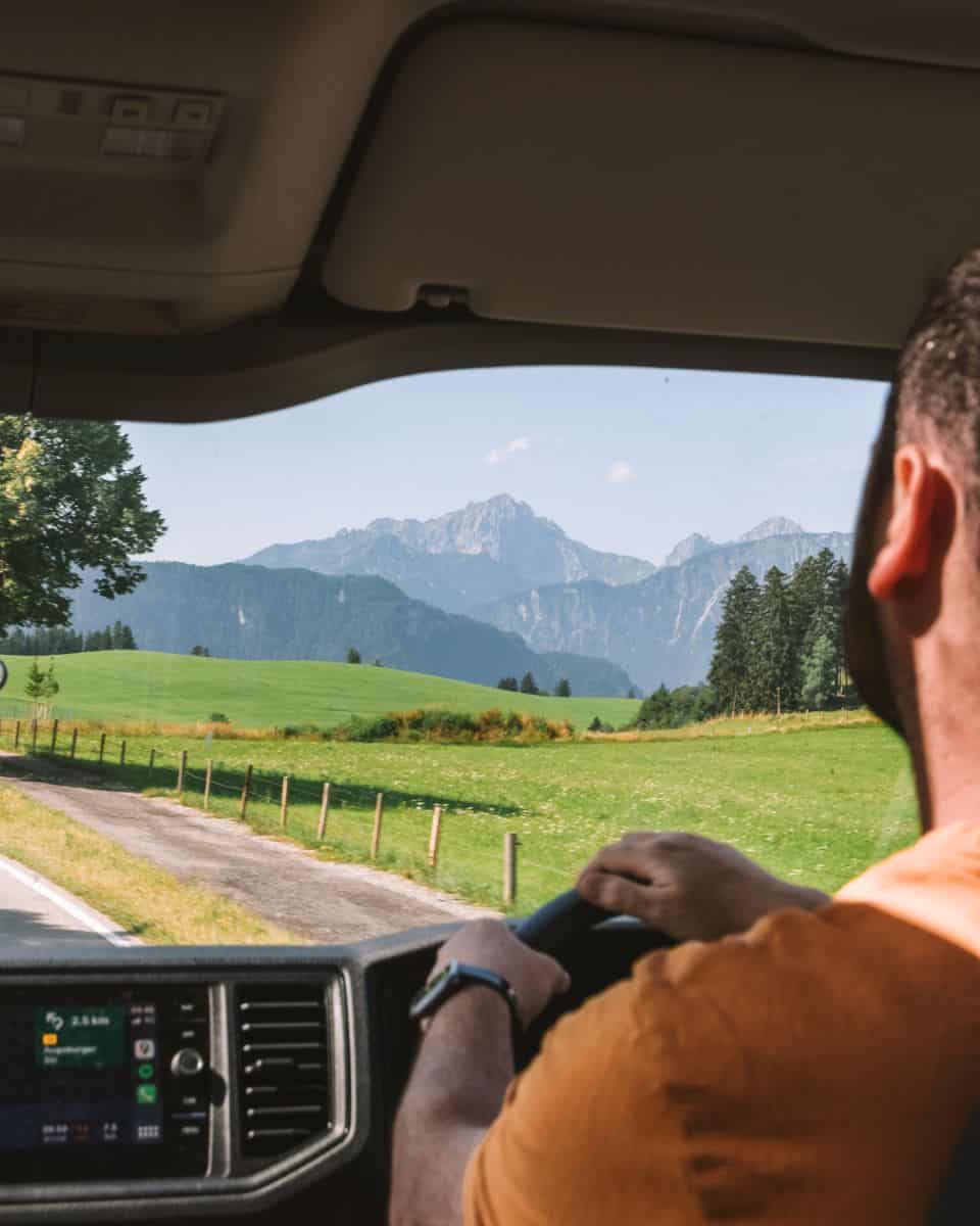 Chris driving the campervan with the mountains in front of him