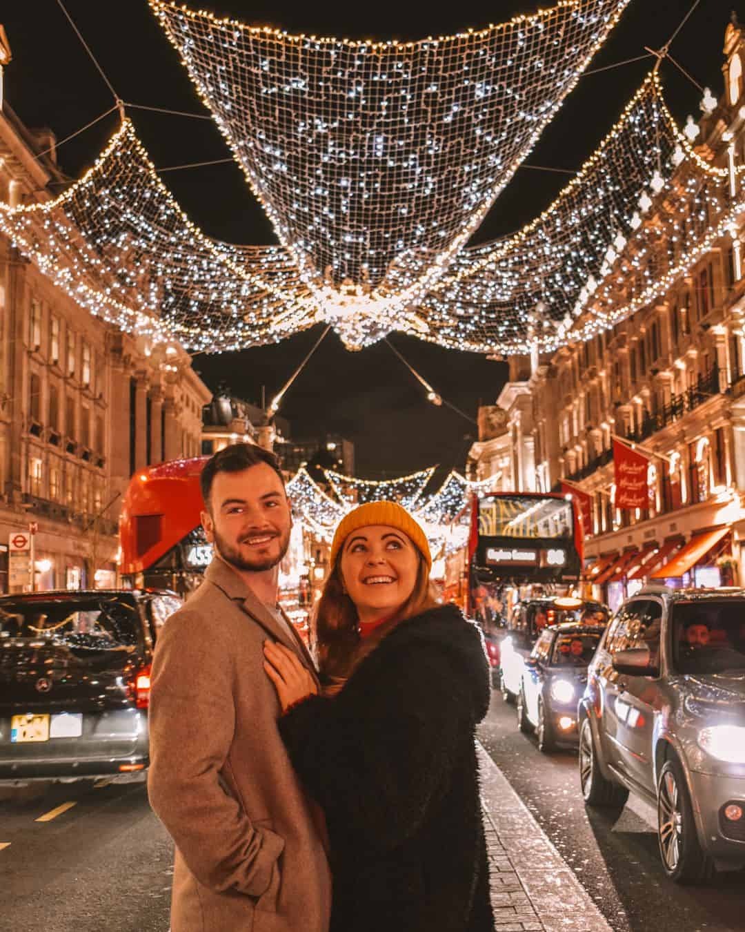 Reanna and Chris stood beneath the angels Christmas lights, on Regents Street