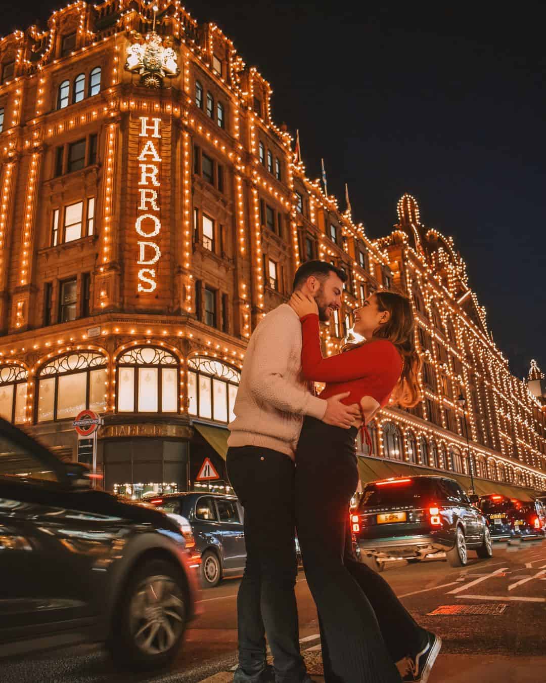 Chris and Reanna stood in front of Harrods lit up at Christmas