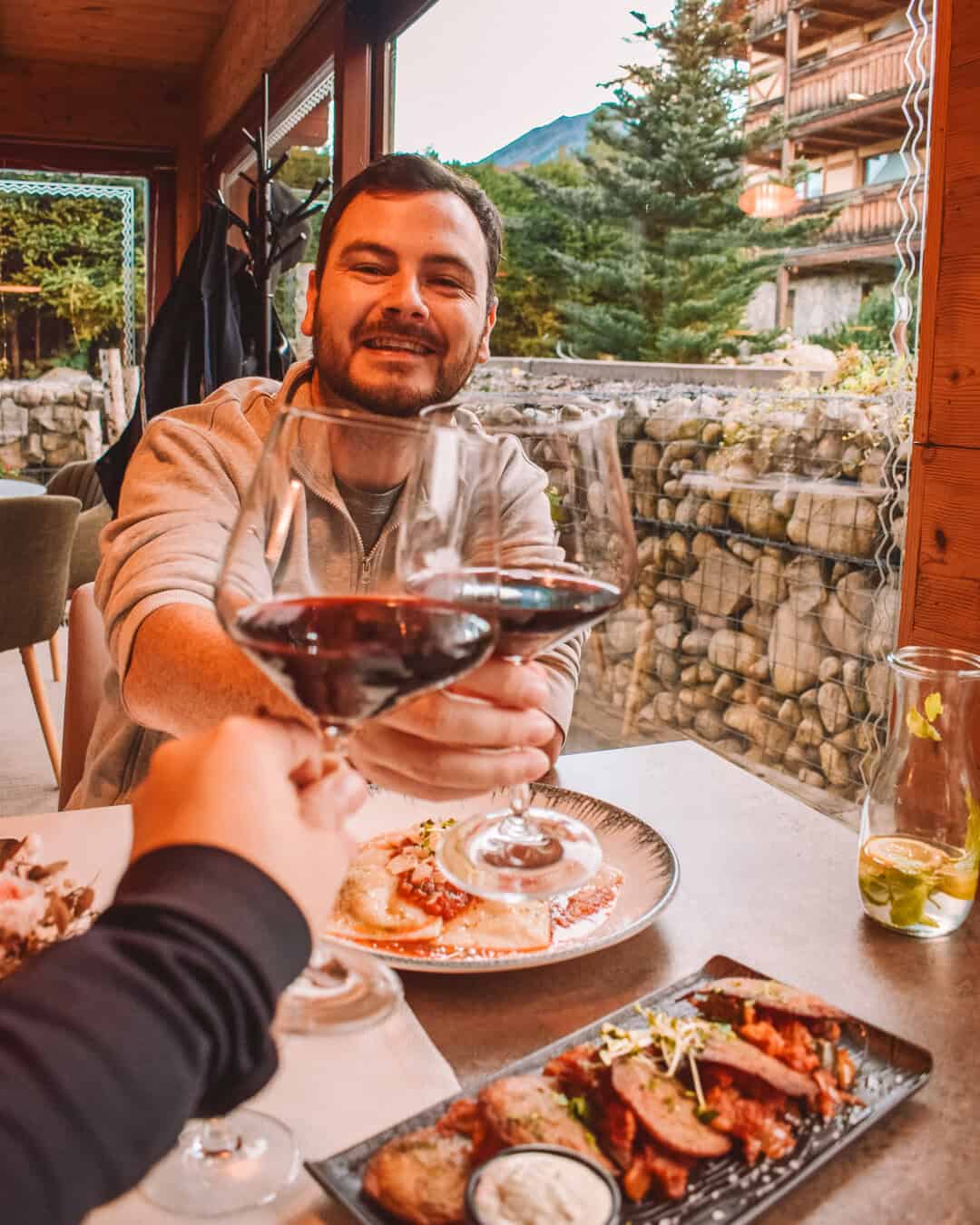 Chris with red wine cheersing Reanna at Aplend Hotel