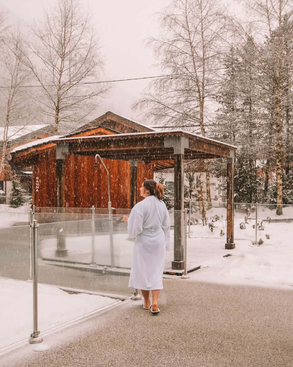 Reanna walking in the snow to the sauna in Hôtel Les Aiglons Chamonix's spa